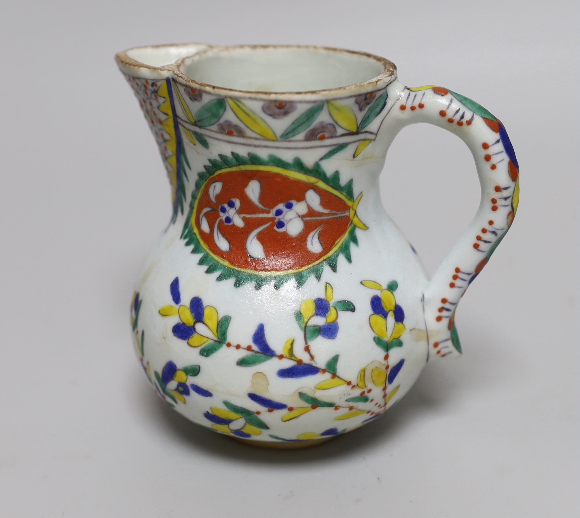 Turkish Kutahya pottery jug hand painted with stylised flowers, 12.5cm high